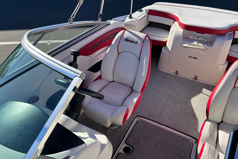 Slide: The Image of 2010 Sea Ray 205 Sport boat interior with red and white seating. - 10