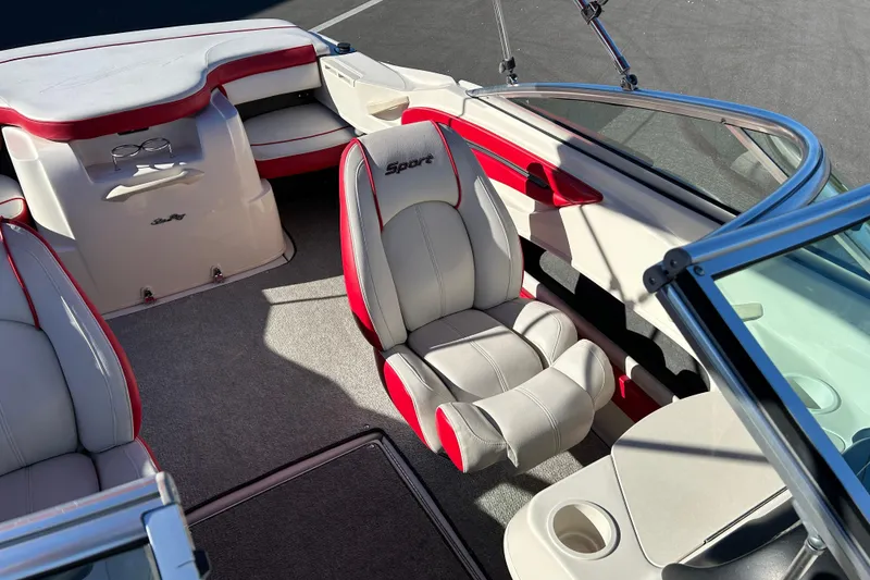 Slide: The Image of Interior of a 2010 Sea Ray 205 Sport boat with red and white seating. - 11