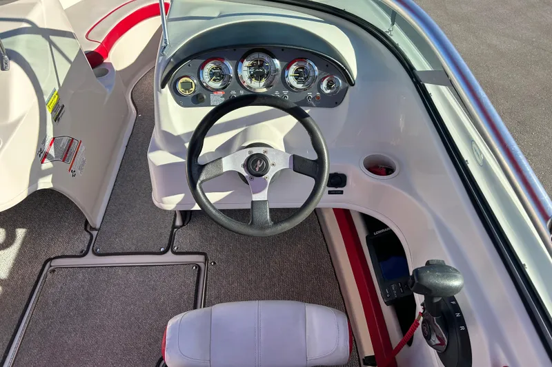 Slide: The Image of 2010 Sea Ray 205 Sport boat dashboard with steering wheel and control panel. - 12