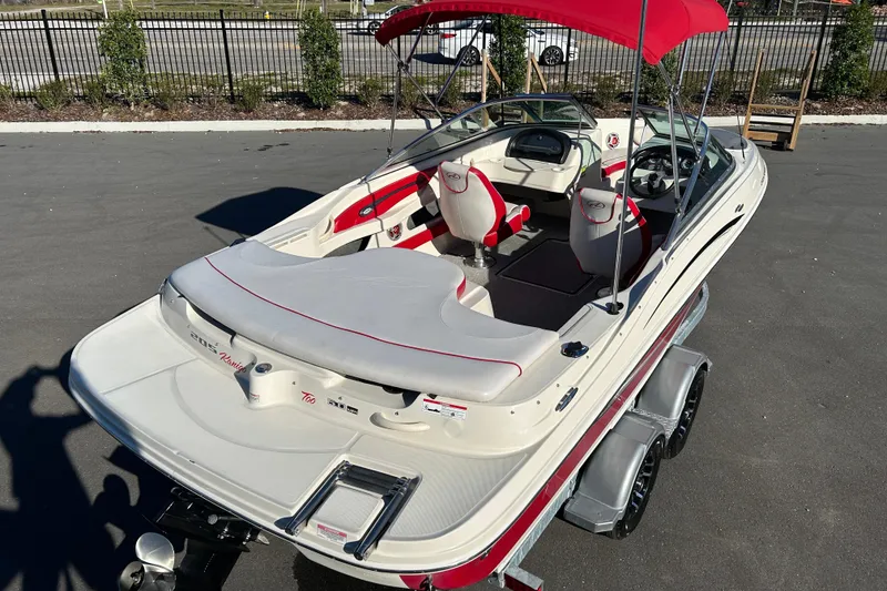 Slide: The Image of 2010 Sea Ray 205 Sport boat with red canopy and dual trailer. - 7