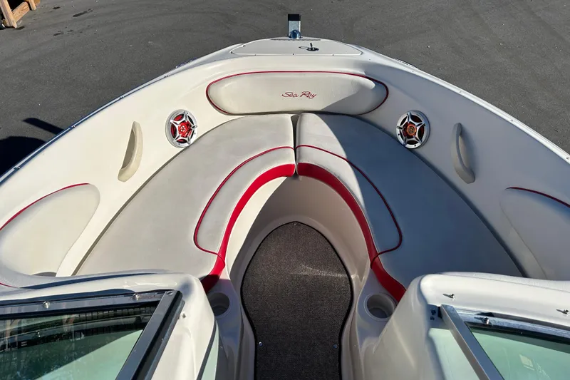 Slide: The Image of 2010 Sea Ray 205 Sport boat interior with red and white seating and speakers. - 8