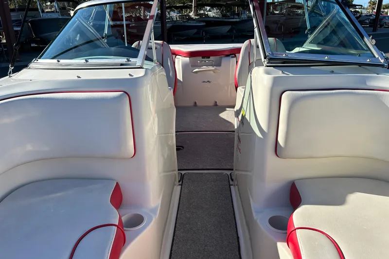Slide: The Image of 2010 Sea Ray 205 Sport boat interior with white and red seating, open cockpit view. - 9