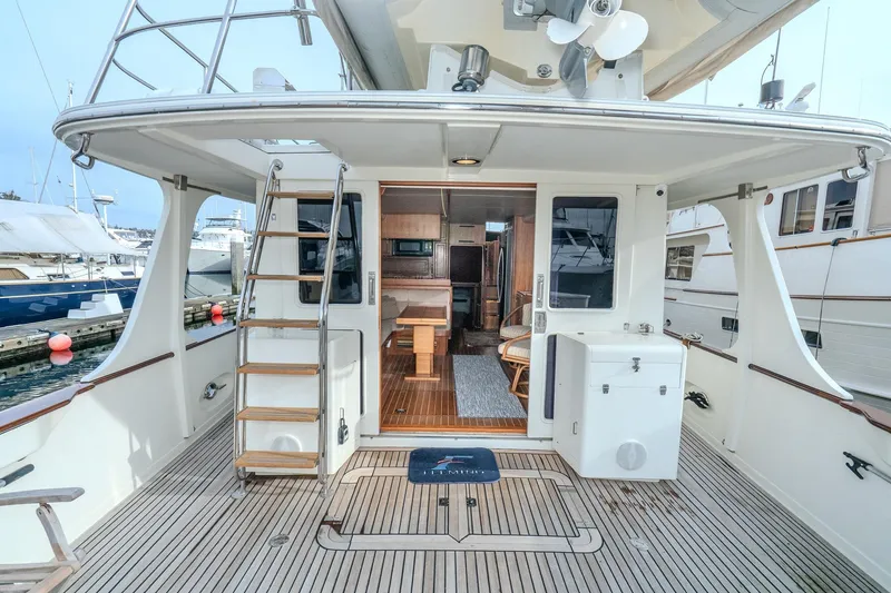 Slide: The Image of 2001 Fleming 55 Pilothouse yacht deck with ladder and interior view. - 10