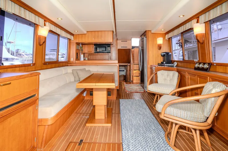 Slide: The Image of Luxurious interior of 2001 Fleming 55 Pilothouse yacht with elegant wood finishes and comfortable seating. - 11