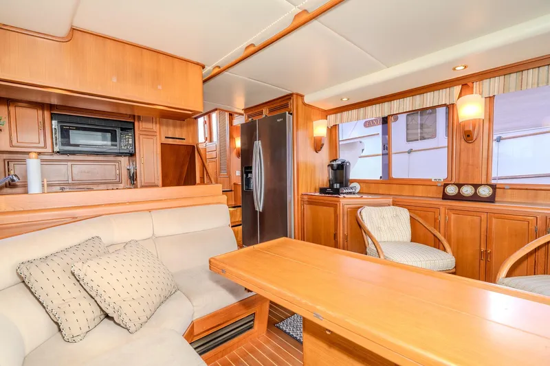 Slide: The Image of Luxurious interior of 2001 Fleming 55 Pilothouse yacht with modern kitchen and cozy seating area. - 14