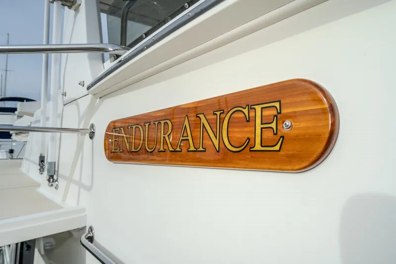 Slide: The Image of 2001 Fleming 55 Pilothouse yacht with "Endurance" nameplate on wooden plaque. - 2