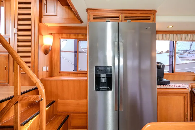 Slide: The Image of Luxurious 2001 Fleming 55 Pilothouse interior with wooden cabinetry and modern appliances. - 21