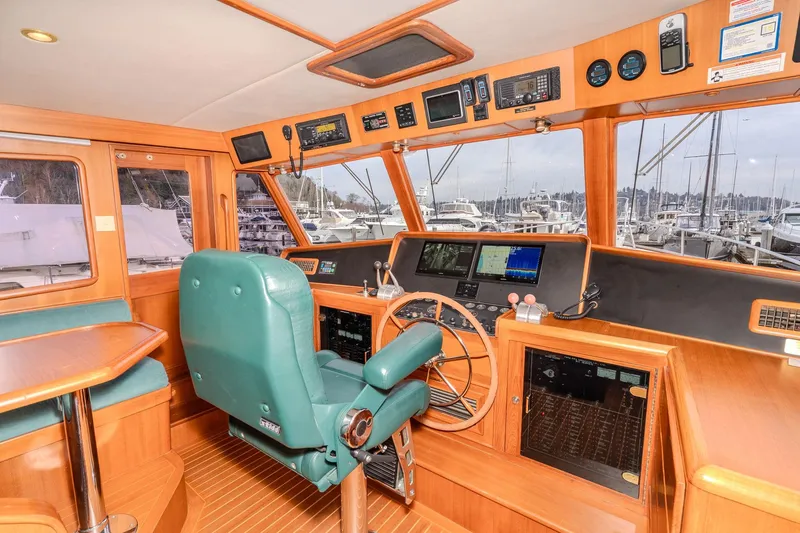 Slide: The Image of Pilothouse interior of 2001 Fleming 55 yacht with navigation equipment and marina view. - 24