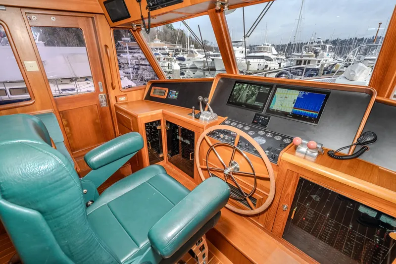 Slide: The Image of Pilothouse interior of 2001 Fleming 55 yacht with navigation equipment and green captain's chair. - 25