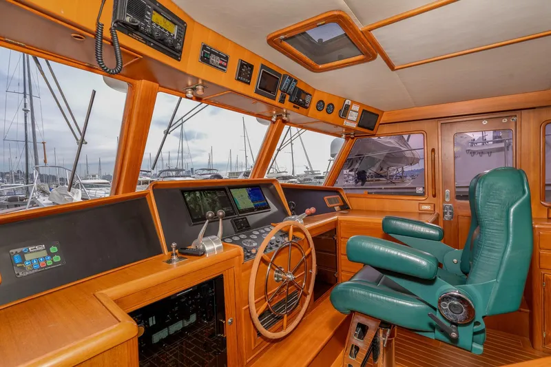 Slide: The Image of Pilothouse interior of 2001 Fleming 55 yacht with green captain's chair and navigation equipment. - 28
