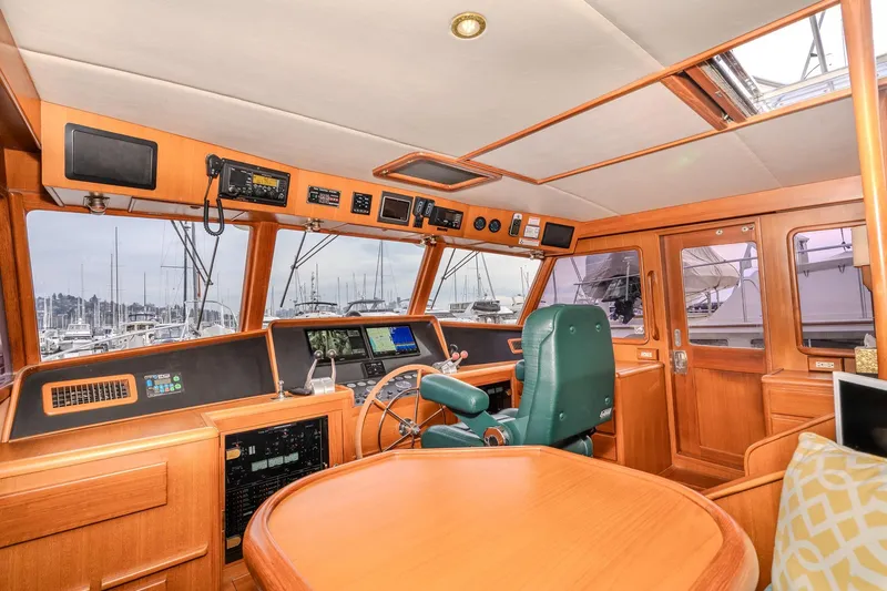 Slide: The Image of Pilothouse interior of 2001 Fleming 55 yacht with navigation equipment and green captain's chair. - 30