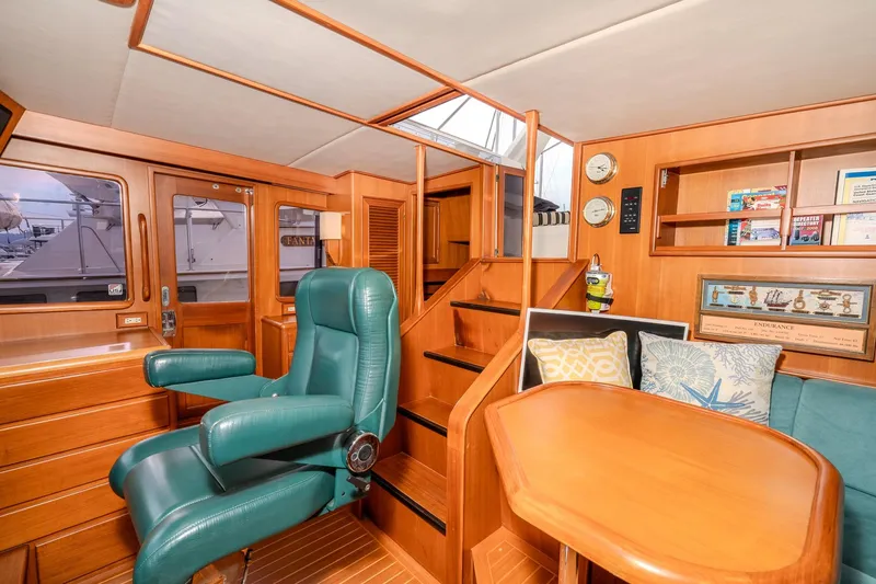 Slide: The Image of Luxurious 2001 Fleming 55 Pilothouse interior with wood finish and green seating. - 32