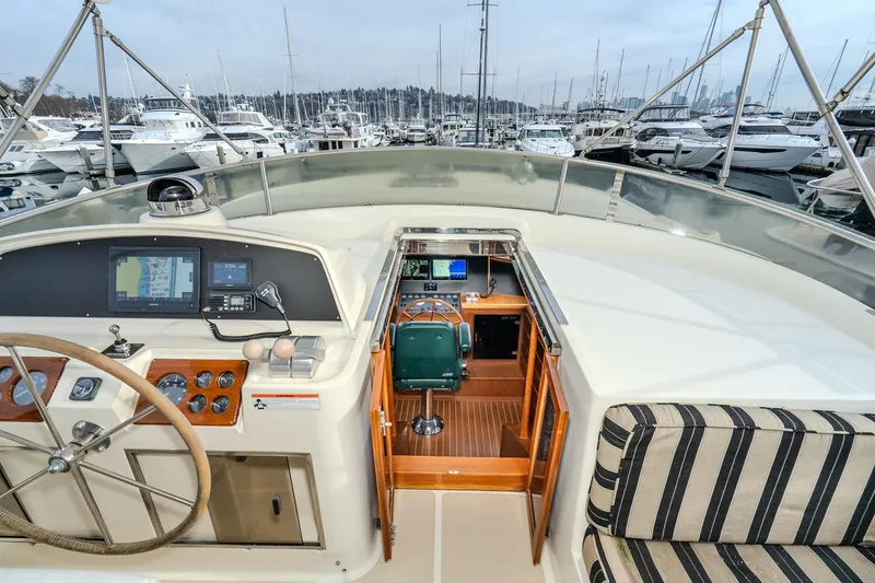 Slide: The Image of Pilothouse of 2001 Fleming 55 yacht with navigation equipment and marina view. - 38
