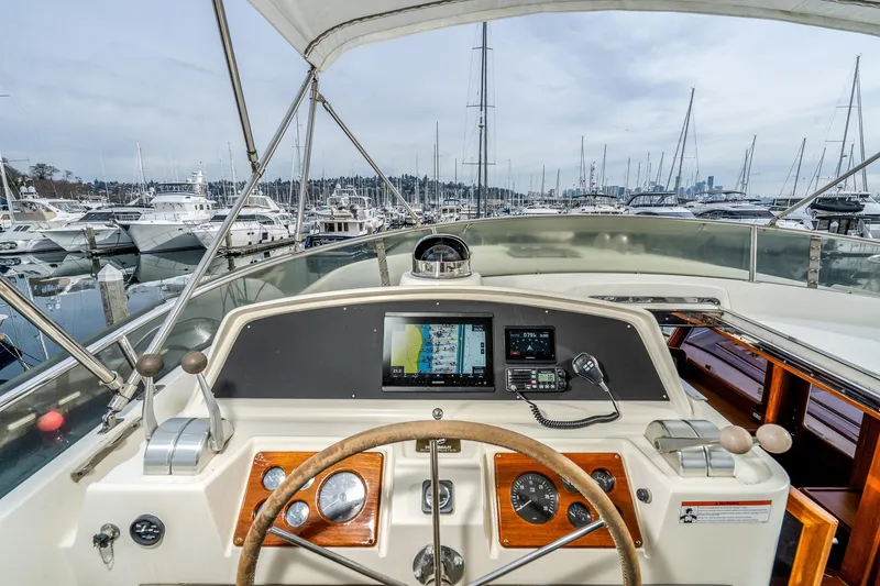 Slide: The Image of Pilothouse view of 2001 Fleming 55 yacht, featuring navigation equipment and marina backdrop. - 39