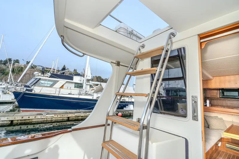Slide: The Image of 2001 Fleming 55 Pilothouse yacht interior with ladder and marina view. - 4