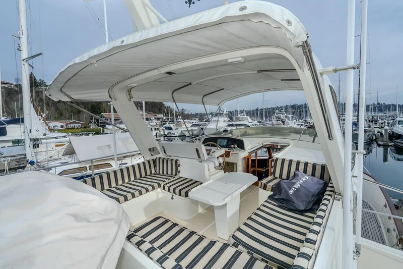 Slide: The Image of 2001 Fleming 55 Pilothouse yacht with striped seating at marina. - 43
