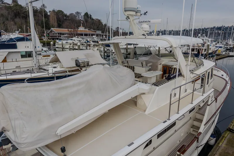 Slide: The Image of 2001 Fleming 55 Pilothouse yacht docked at marina, covered and equipped with Garmin radar. - 46