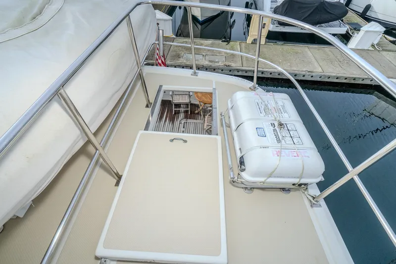 Slide: The Image of 2001 Fleming 55 Pilothouse deck with safety equipment and marina view. - 48