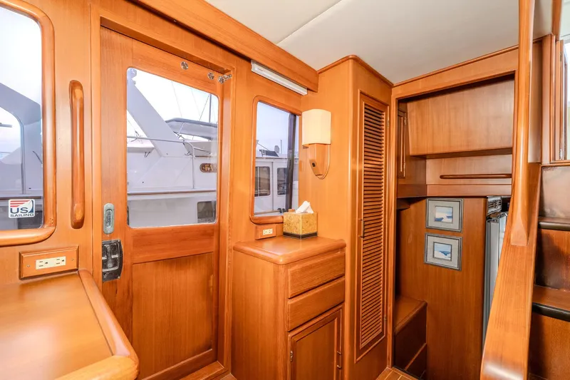 Slide: The Image of Interior of 2001 Fleming 55 Pilothouse yacht with wooden cabinetry and nautical decor. - 53