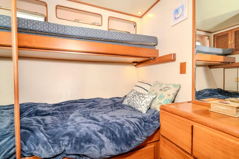 Slide: The Image of Cozy cabin interior of 2001 Fleming 55 Pilothouse with bunk beds and wooden furnishings. - 56
