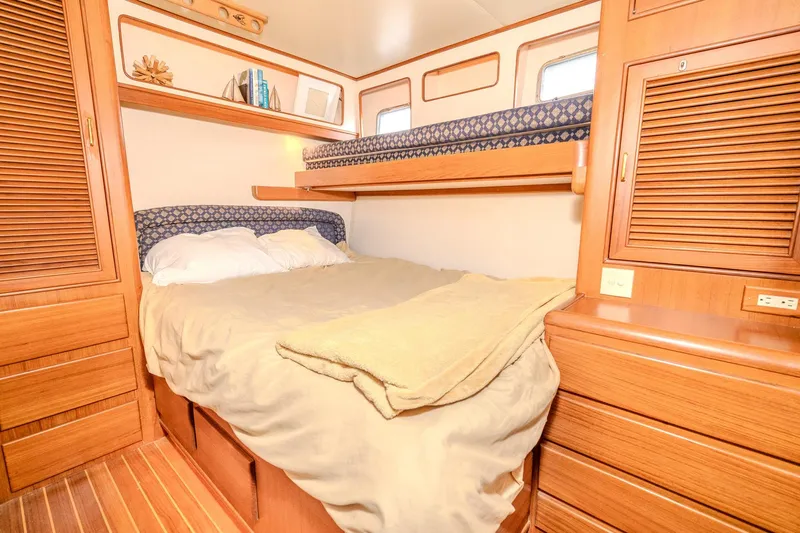Slide: The Image of Cozy cabin interior of 2001 Fleming 55 Pilothouse with wooden furnishings and comfortable bedding. - 58