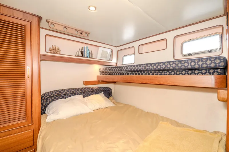 Slide: The Image of Cozy cabin interior of 2001 Fleming 55 Pilothouse with bunk beds and wooden accents. - 59