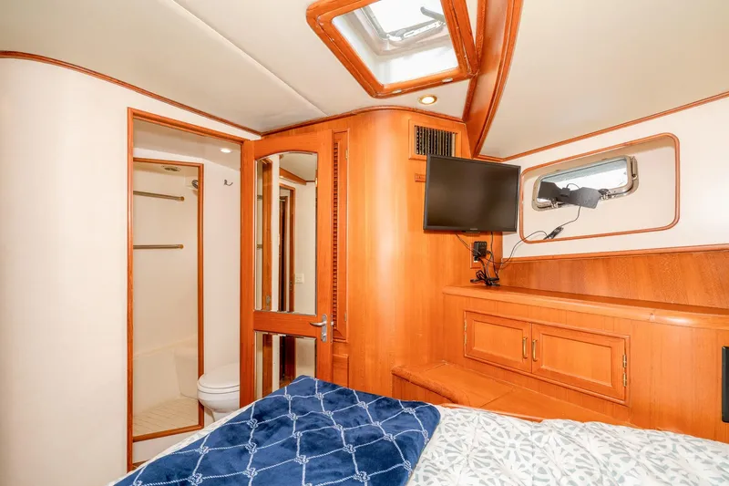 Slide: The Image of Luxurious cabin interior of 2001 Fleming 55 Pilothouse yacht with wood finishes and modern amenities. - 69