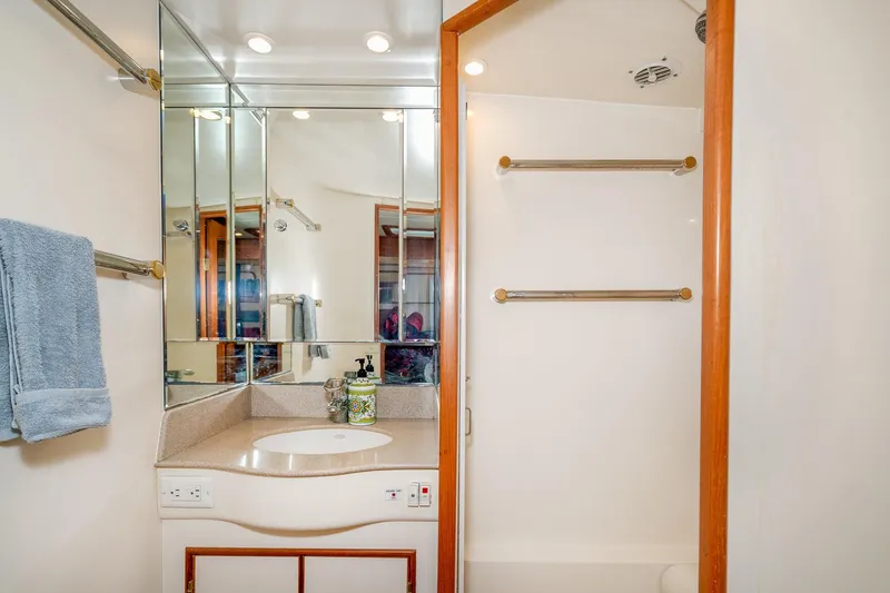 Slide: The Image of Luxurious bathroom in 2001 Fleming 55 Pilothouse yacht with mirrored cabinets and shower. - 70