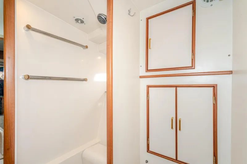 Slide: The Image of Bathroom interior of 2001 Fleming 55 Pilothouse yacht with storage cabinets and towel racks. - 71