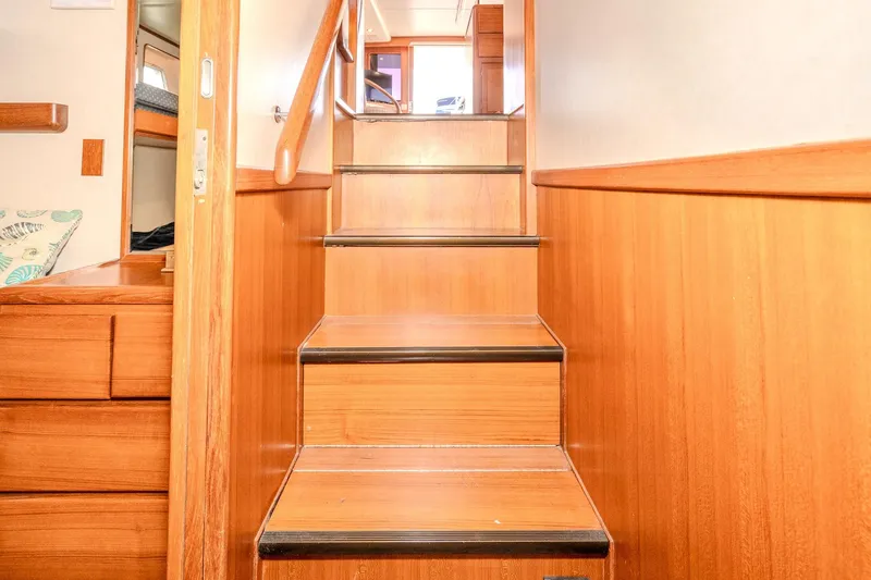 Slide: The Image of Wooden staircase inside 2001 Fleming 55 Pilothouse yacht, leading to upper deck. - 74