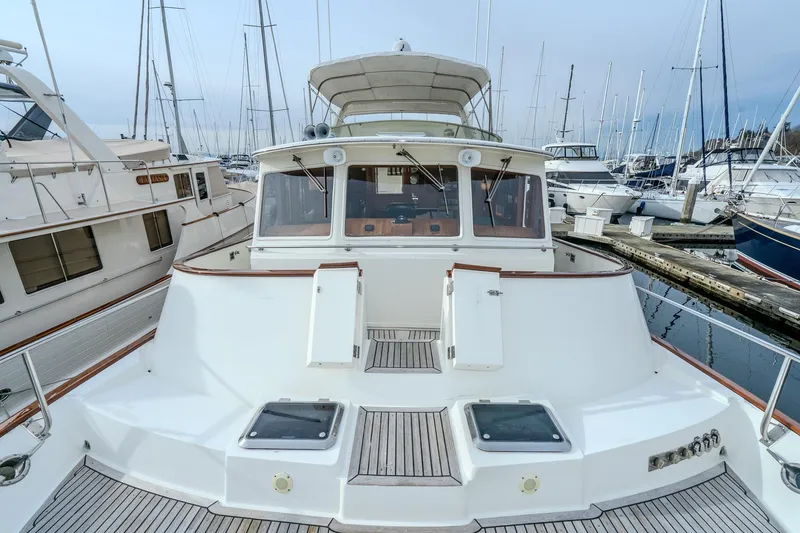 Slide: The Image of 2001 Fleming 55 Pilothouse yacht docked in marina, surrounded by other boats. - 76