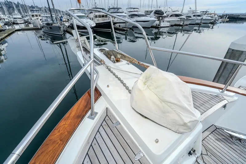 Slide: The Image of Bow of 2001 Fleming 55 Pilothouse yacht docked in marina, featuring anchor and railing. - 79