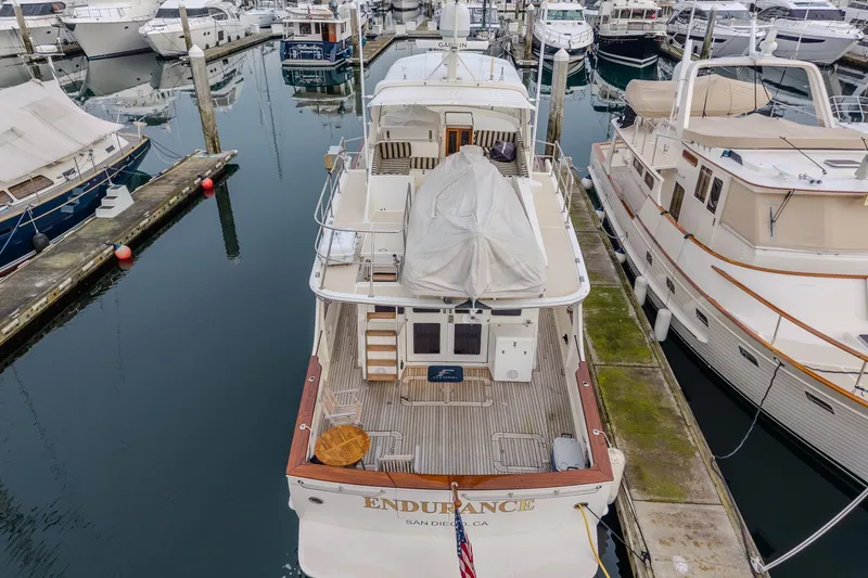 Slide: The Image of 2001 Fleming 55 Pilothouse yacht docked at marina, rear view, named "Endurance." - 84