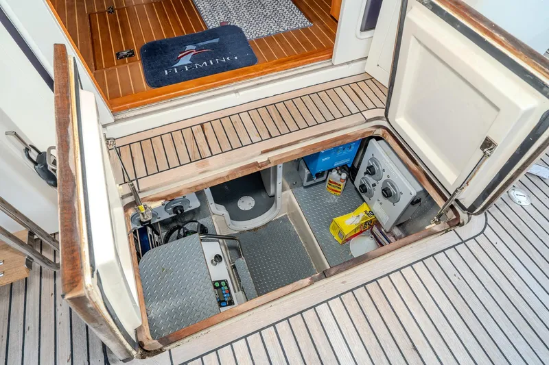 Slide: The Image of Engine room access on 2001 Fleming 55 Pilothouse yacht with open hatch and equipment. - 86
