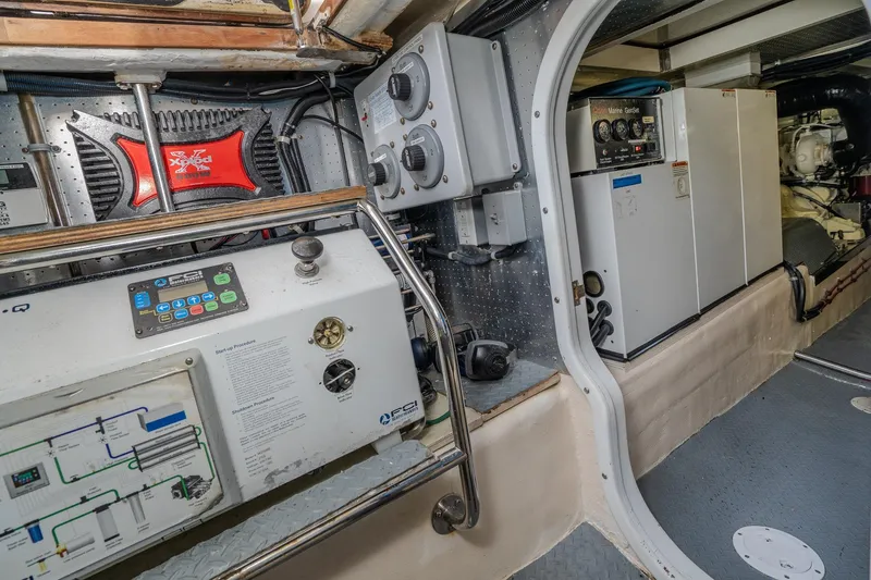 Slide: The Image of Engine room of 2001 Fleming 55 Pilothouse yacht with control panels and equipment. - 87