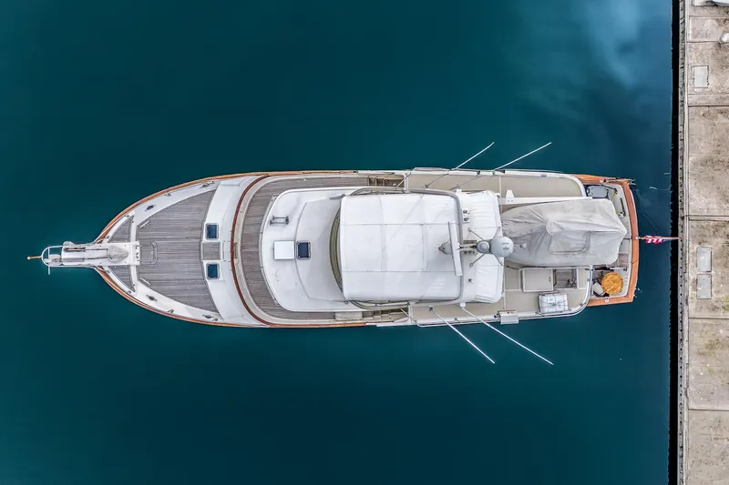 Slide: The Image of Aerial view of 2001 Fleming 55 Pilothouse yacht docked in calm waters. - 94