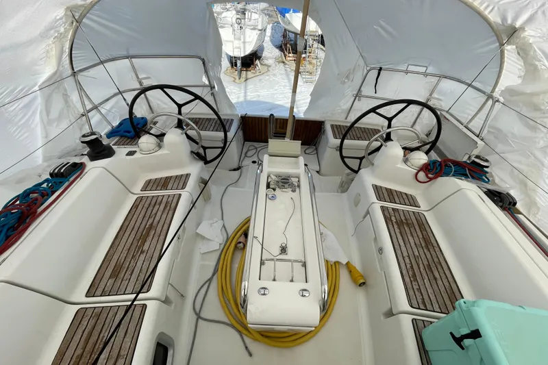 Slide: The Image of 2014 Jeanneau Sun Odyssey 439 cockpit with dual steering wheels and teak seating. - 18