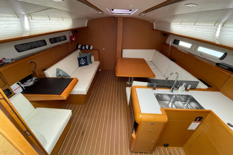 Slide: The Image of Interior of 2014 Jeanneau Sun Odyssey 439 sailboat with modern seating and kitchen area. - 19