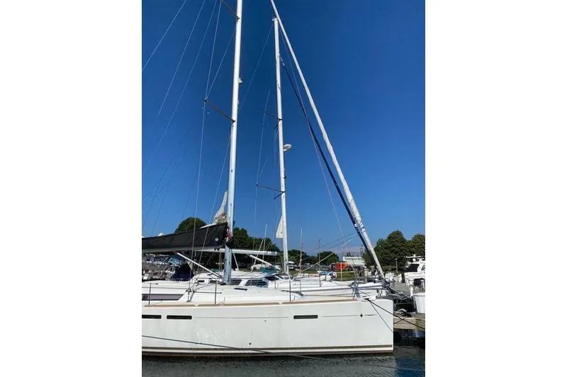 Slide: The Image of 2014 Jeanneau Sun Odyssey 439 sailboat docked under clear blue sky. - 3