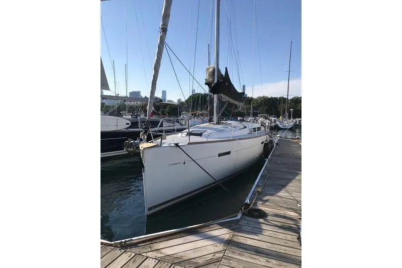 Slide: The Image of 2014 Jeanneau Sun Odyssey 439 sailboat docked at marina under clear sky. - 5