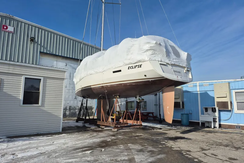Slide: The Image of 2014 Jeanneau Sun Odyssey 439 sailboat, named Eclipse, covered and docked in a marina. - 7