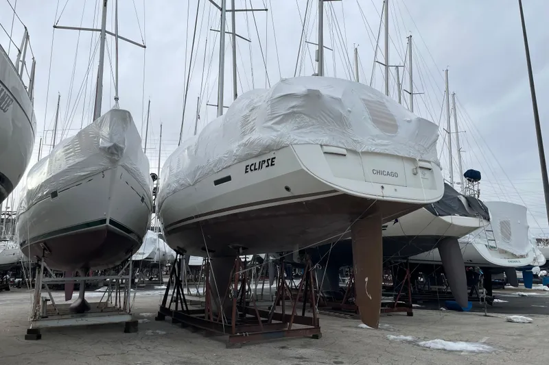 Slide: The Image of 2014 Jeanneau Sun Odyssey 439 sailboat in dry dock, covered for storage. - 9