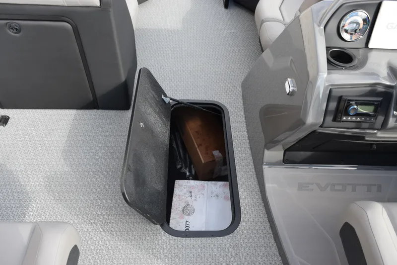 Slide: The Image of Open storage compartment on 2026 Evotti 523CS boat interior. - 16