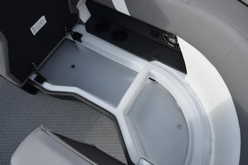 Slide: The Image of 2026 Evotti 523CS boat storage compartment with gray interior and speaker detail. - 17