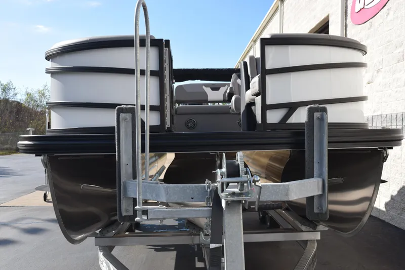 Slide: The Image of 2026 Evotti 523CS pontoon boat on trailer, front view, parked outdoors. - 3