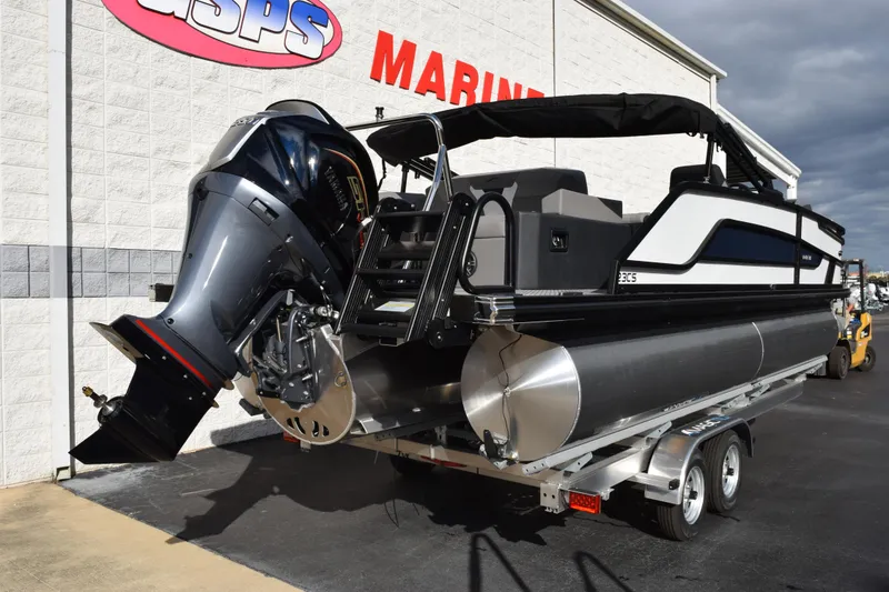 Slide: The Image of 2026 Evotti 523CS pontoon boat on trailer, featuring a powerful outboard motor. - 4