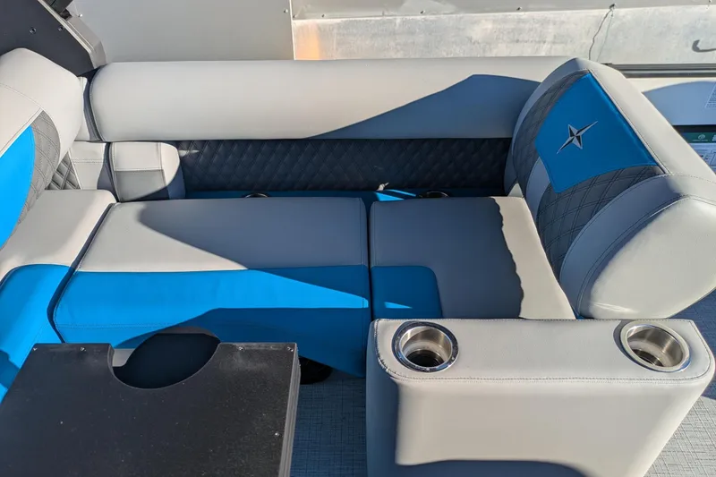 Slide: The Image of 2026 Berkshire 23SB2 STS boat seating with blue and gray upholstery, featuring cup holders. - 11