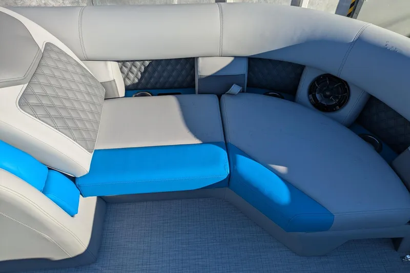 Slide: The Image of 2026 Berkshire 23SB2 STS boat interior with gray and blue cushioned seating. - 14