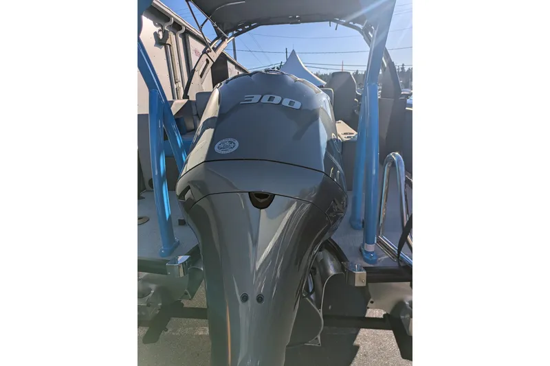 Slide: The Image of 2026 Berkshire 23SB2 STS boat with powerful 300 horsepower engine, docked under clear sky. - 16