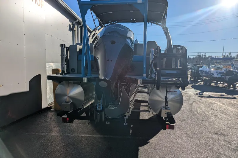 Slide: The Image of 2026 Berkshire 23SB2 STS pontoon boat with outboard motor in a sunny marina. - 17